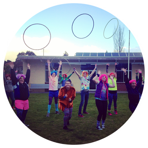 Group with wigs throwing hula hoops into the air at a 21st birthday party in Melbourne