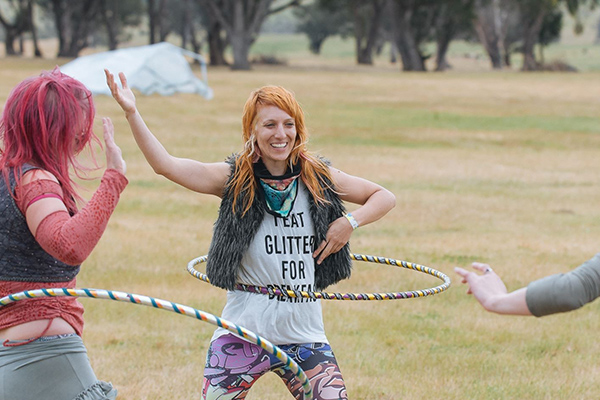 Donna Sparx teaching people to hula hoop at an outdoor festival