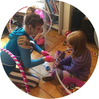 Donna Sparx teaching the birthday girl how to make a hula hoop at her hula hoop birthday party
