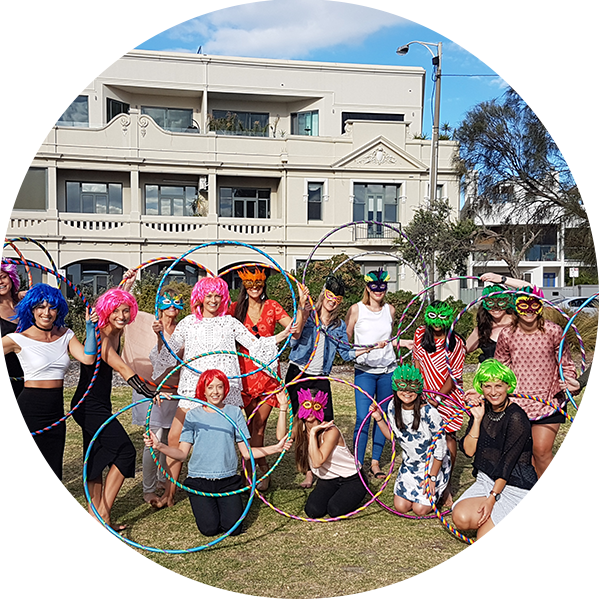 Hula Hoop Hens Party in St Kilda with group of friends with hula hoops dressed up in Eighties wigs and lycra