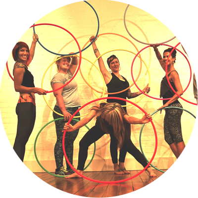 Hula Hoopers posing with their hoops in a Hoop Sparx hula hoop class