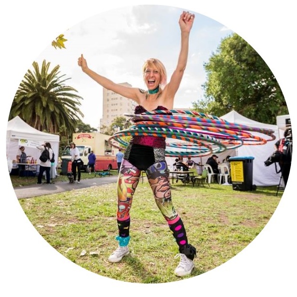 Hula hooper Donna Sparx with mutiple hoops performing at youth festival | Hoop Sparx Event Entertainment